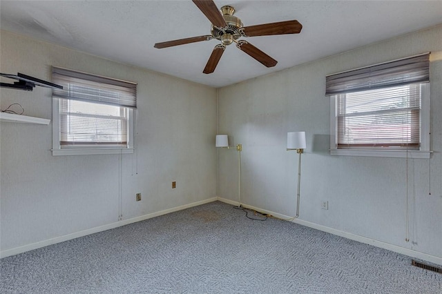 spare room featuring ceiling fan and light carpet