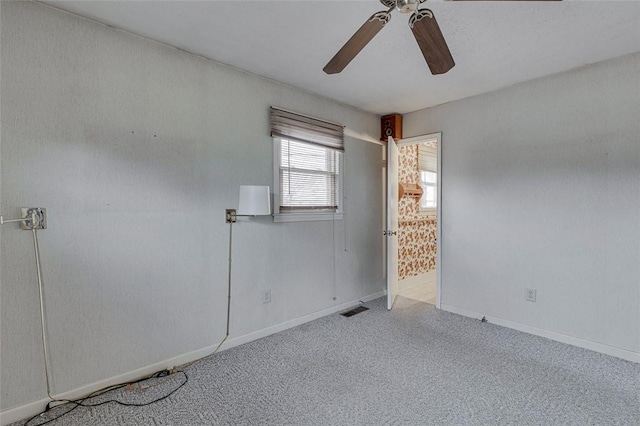 carpeted empty room with ceiling fan