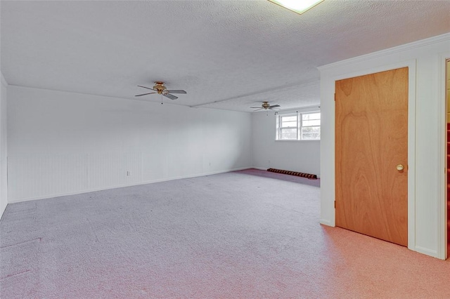 carpeted empty room with ceiling fan and a textured ceiling