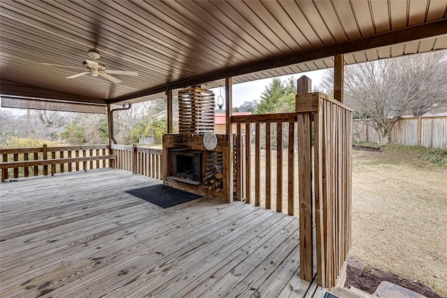 deck featuring ceiling fan and an outdoor fireplace