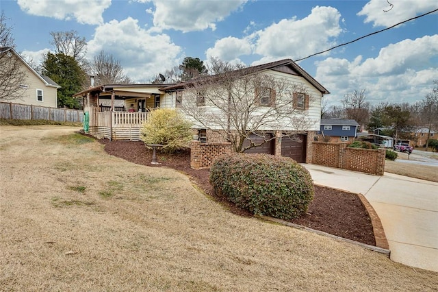 view of property exterior with a garage, a yard, and covered porch