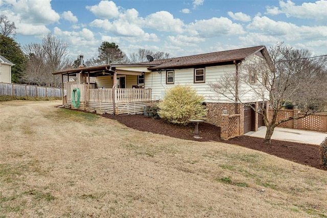 view of front of property with a porch, a garage, and a front yard