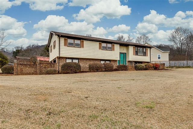 raised ranch featuring a front yard