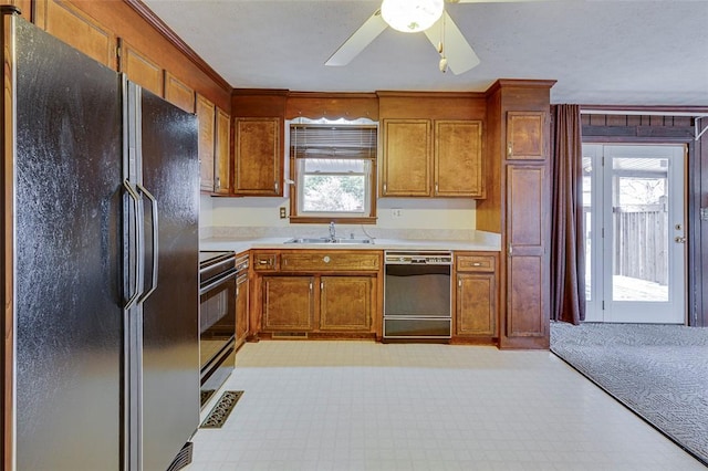 kitchen with sink, black appliances, and ceiling fan