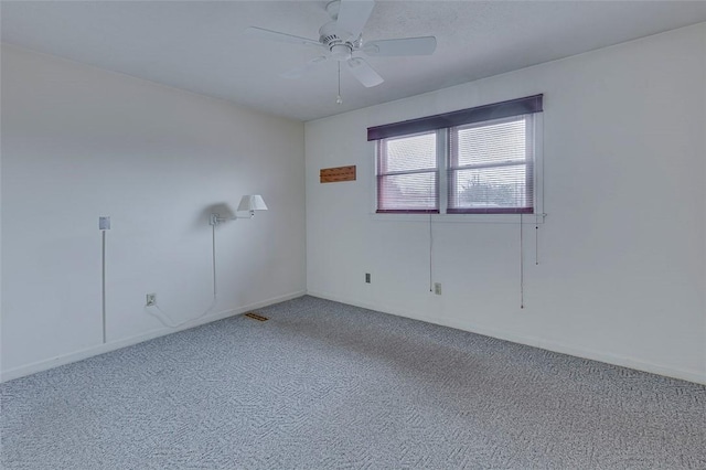 carpeted spare room with ceiling fan