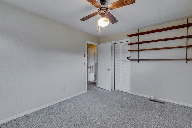 unfurnished bedroom featuring carpet floors, ceiling fan, and a closet