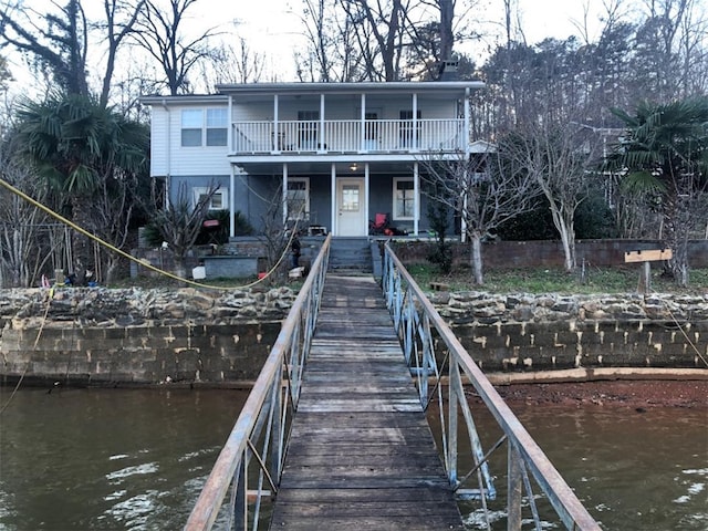 view of dock with a water view and a balcony