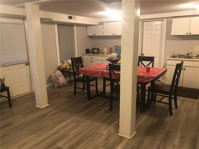 dining area featuring dark hardwood / wood-style floors and sink