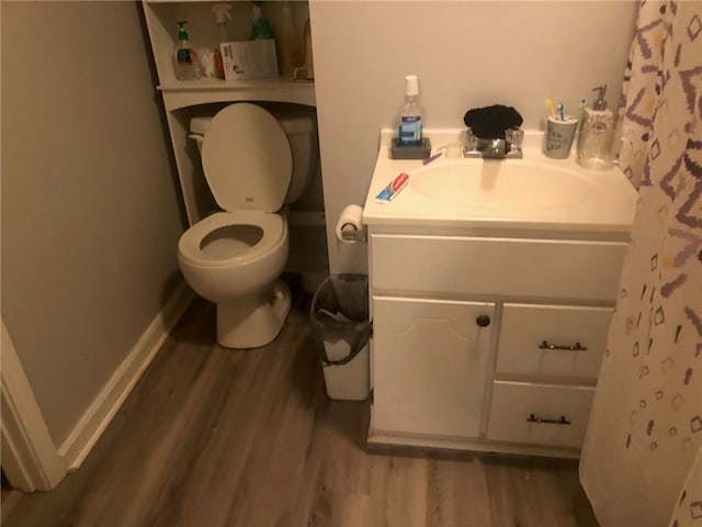 bathroom featuring vanity, wood-type flooring, and toilet