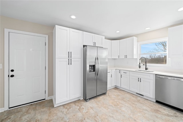 kitchen with white cabinetry, sink, and appliances with stainless steel finishes