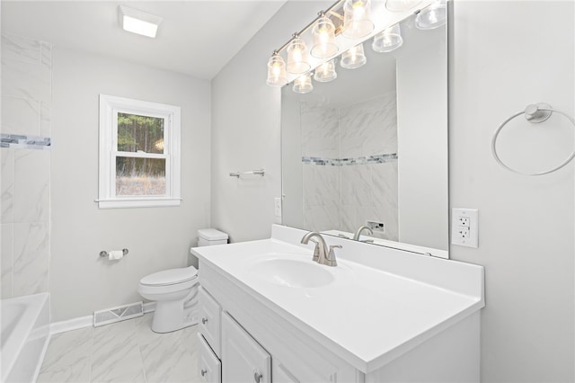 full bathroom featuring vanity, tiled shower / bath, and toilet