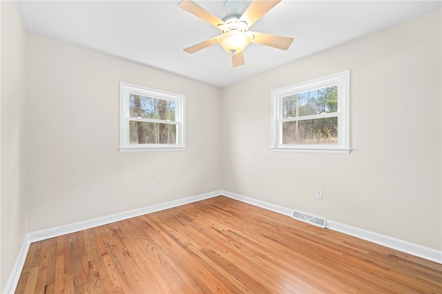 spare room featuring hardwood / wood-style flooring and ceiling fan