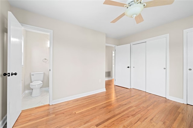 unfurnished bedroom featuring ceiling fan, connected bathroom, a closet, and light hardwood / wood-style flooring