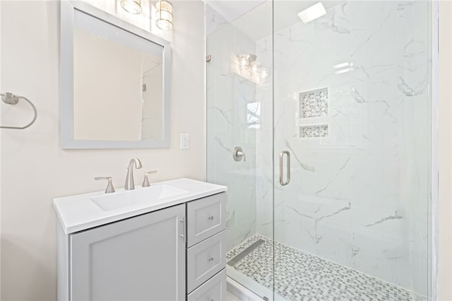 bathroom featuring vanity and a shower with shower door