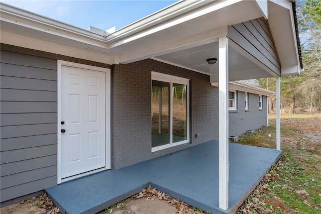 doorway to property with a patio