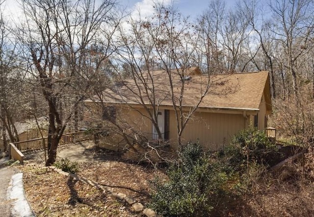 view of home's exterior with roof with shingles