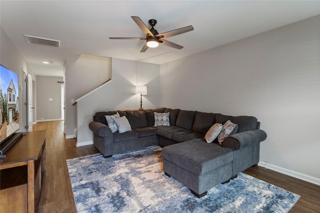 living room featuring dark hardwood / wood-style floors and ceiling fan