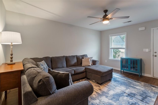 living room featuring dark hardwood / wood-style flooring and ceiling fan