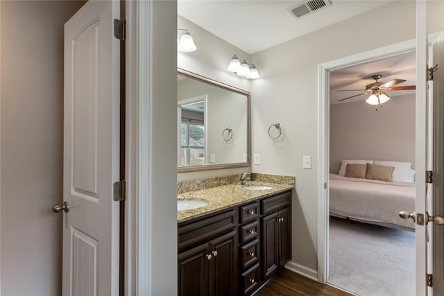 bathroom with hardwood / wood-style flooring, vanity, and ceiling fan