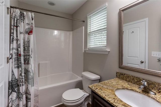 full bathroom featuring vanity, shower / bath combination with curtain, and toilet