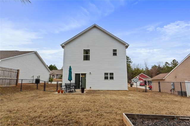 back of house with a yard and central AC