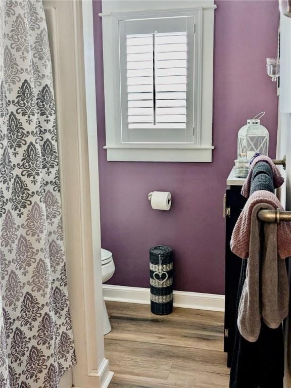 bathroom featuring hardwood / wood-style floors and toilet