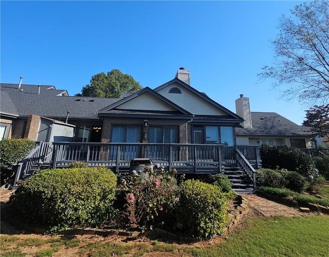 rear view of property featuring a wooden deck