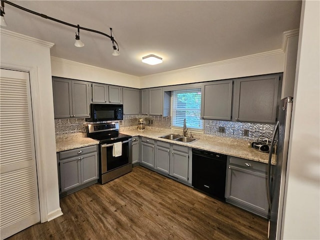 kitchen featuring dark wood-type flooring, sink, gray cabinetry, tasteful backsplash, and black appliances