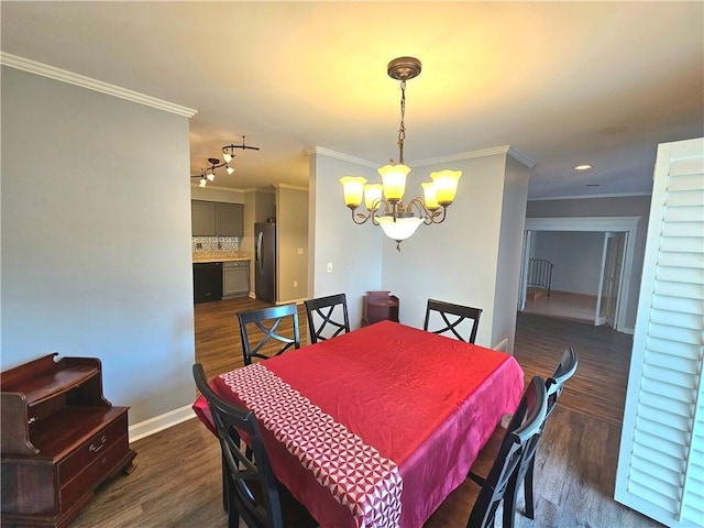 dining room featuring an inviting chandelier, ornamental molding, and dark hardwood / wood-style floors