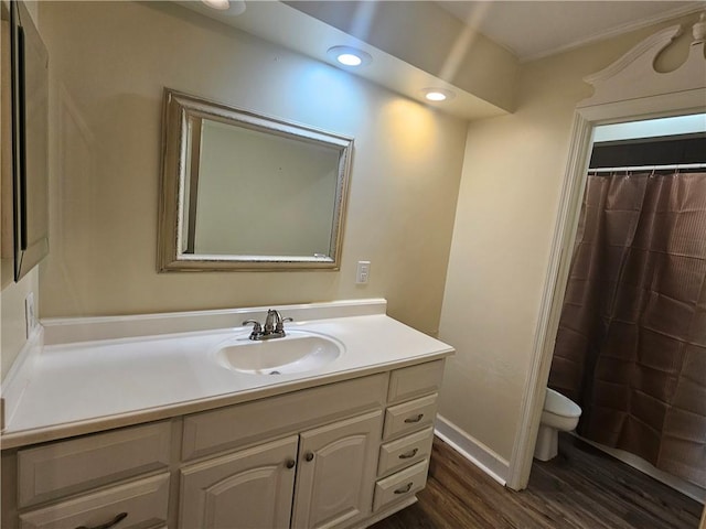 bathroom with vanity, hardwood / wood-style flooring, toilet, and walk in shower