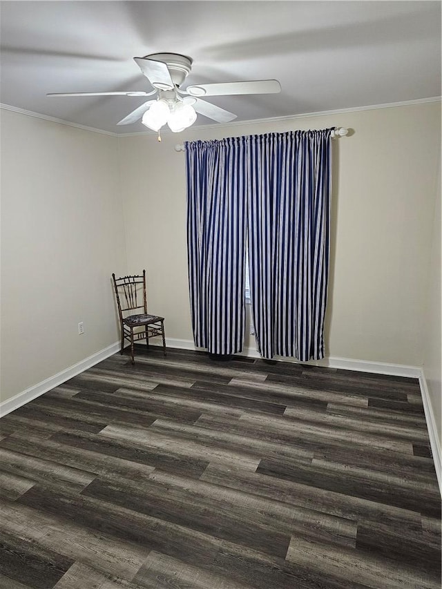 spare room featuring crown molding, dark wood-type flooring, and ceiling fan