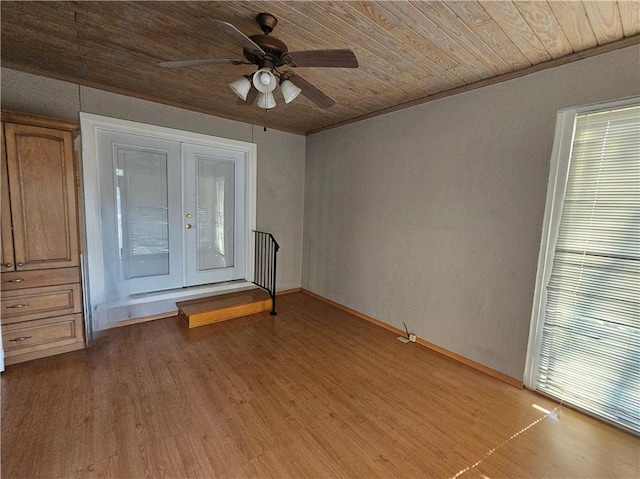 spare room with wood ceiling, ceiling fan, light hardwood / wood-style flooring, and french doors