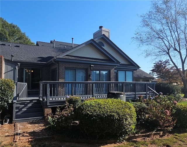 rear view of property featuring a deck