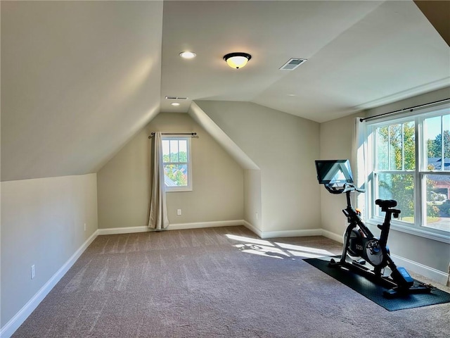 workout room with carpet floors and vaulted ceiling