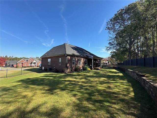 view of side of home featuring a yard and central air condition unit