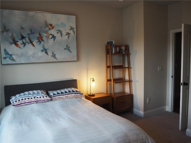 bedroom featuring dark carpet