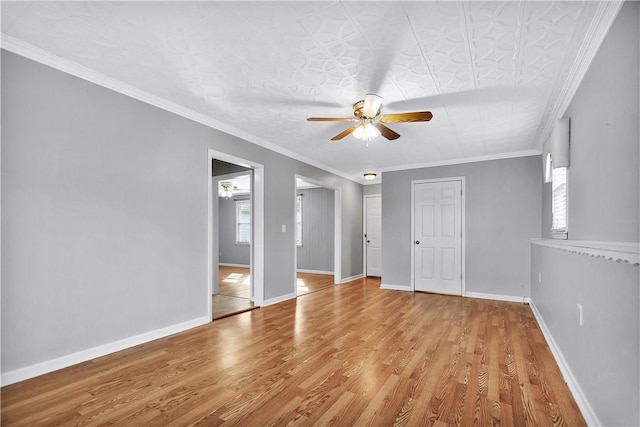 spare room featuring crown molding, light hardwood / wood-style flooring, and ceiling fan