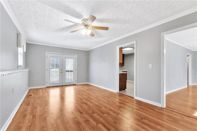 unfurnished room featuring crown molding, light hardwood / wood-style flooring, ceiling fan, and french doors