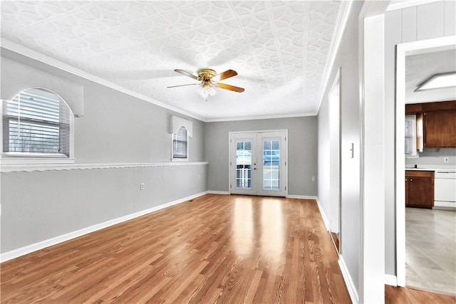 spare room featuring crown molding, light hardwood / wood-style flooring, french doors, and ceiling fan