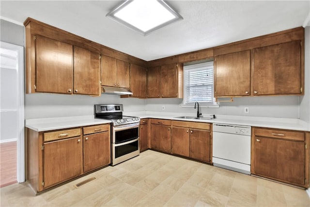 kitchen featuring dishwasher, sink, and double oven range