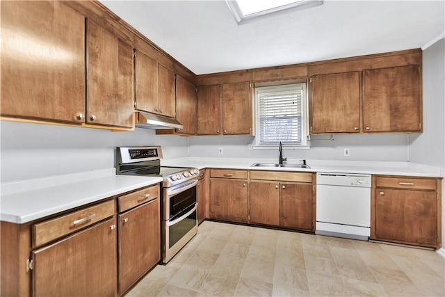 kitchen featuring white dishwasher, sink, and range with two ovens