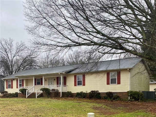 ranch-style house featuring a porch and a front lawn