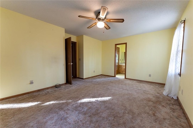 carpeted spare room featuring a textured ceiling and ceiling fan