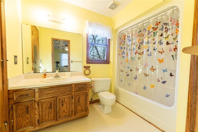 full bathroom with vanity, shower / tub combo with curtain, and toilet