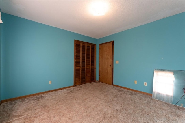 unfurnished bedroom with carpet floors and a closet