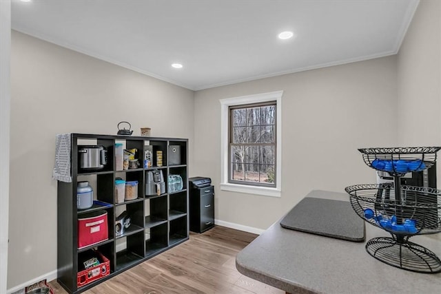 home office with hardwood / wood-style flooring and crown molding