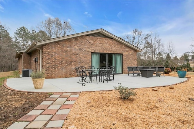 back of property with cooling unit and a patio area