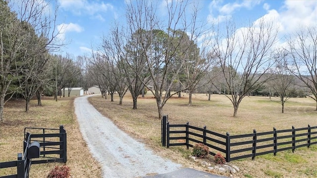 view of property's community with a lawn and a rural view