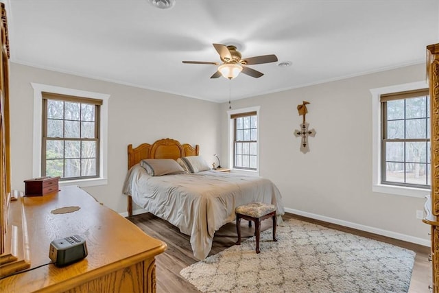 bedroom featuring crown molding, ceiling fan, and light wood-type flooring