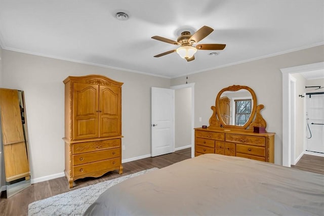 bedroom featuring ceiling fan, ornamental molding, dark hardwood / wood-style floors, and ensuite bathroom